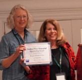 Judie Gorstein awarding member of LWV of Oneonta with the audrey Price Memorial Membership Award