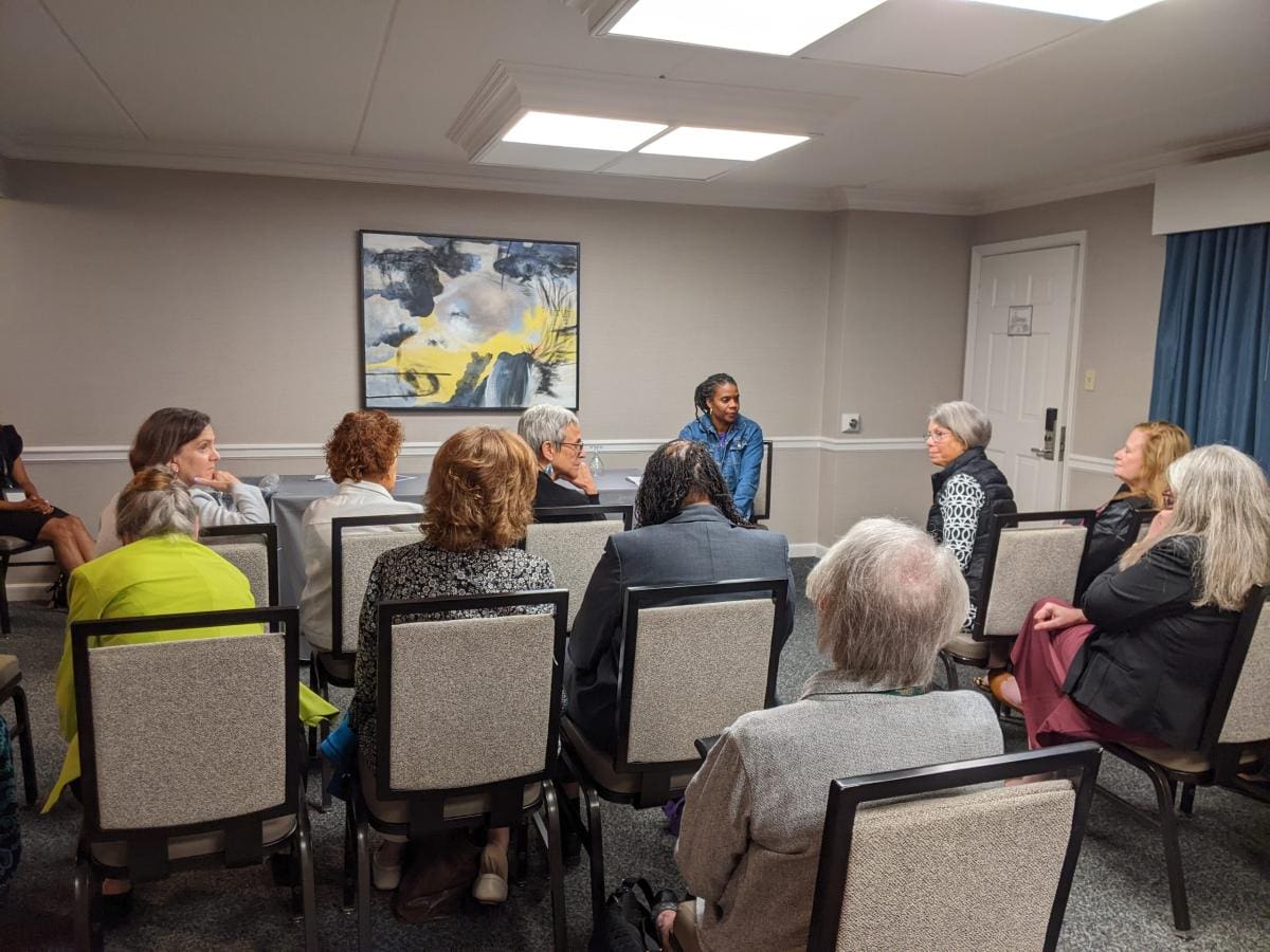 A group of people sitting in chairs in a room.