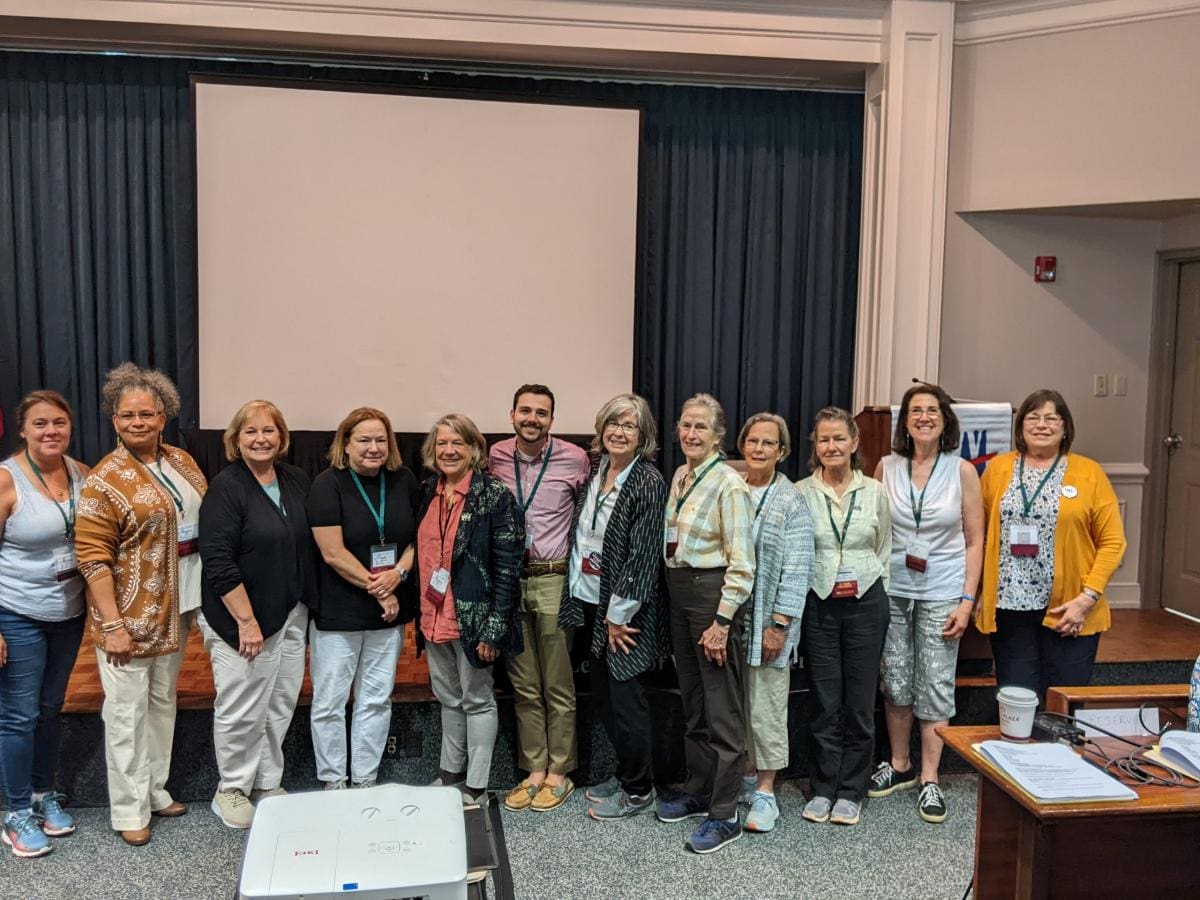 A group of LWV NYS people standing in front of a projector.